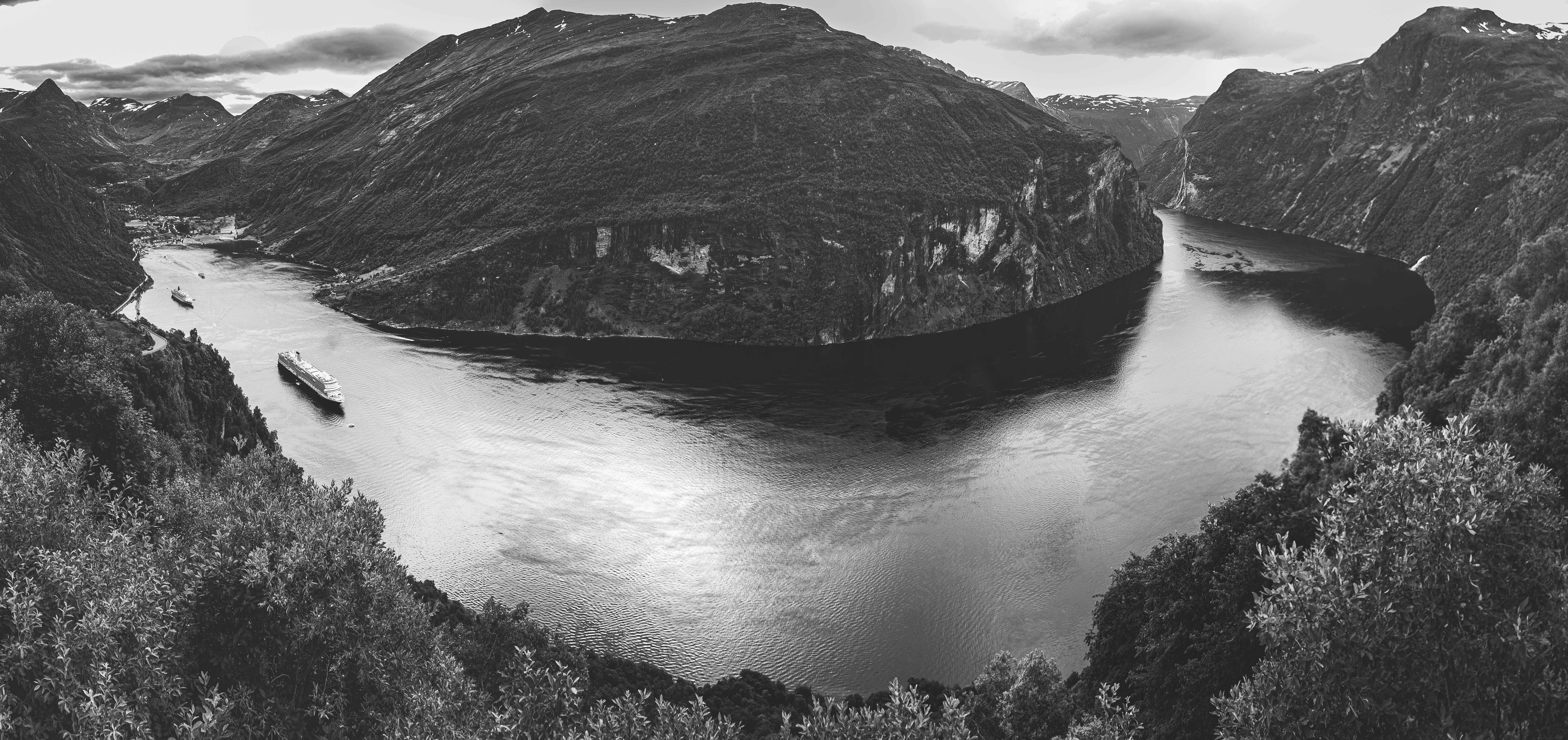 grayscale photo of mountain and river